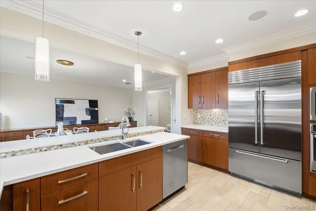 a kitchen with sink refrigerator and microwave