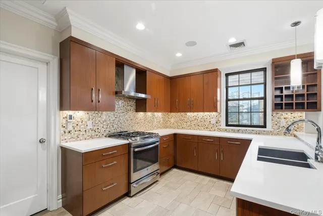 a kitchen with stainless steel appliances granite countertop a sink stove and refrigerator
