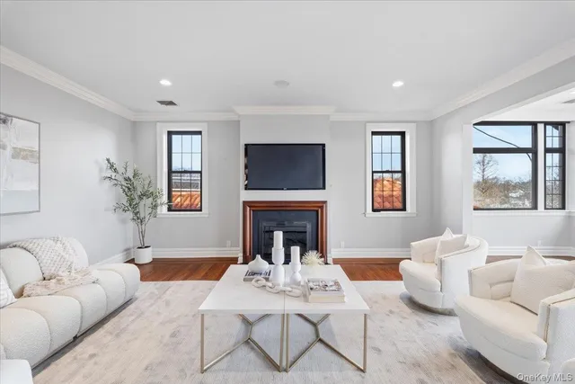 a living room with furniture a fireplace and a flat screen tv