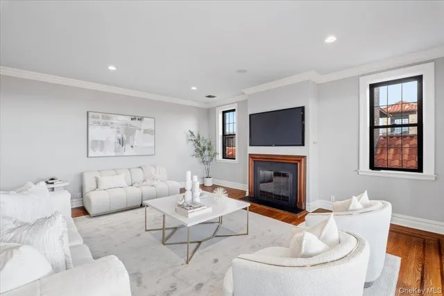 a living room with furniture a fireplace and a flat screen tv