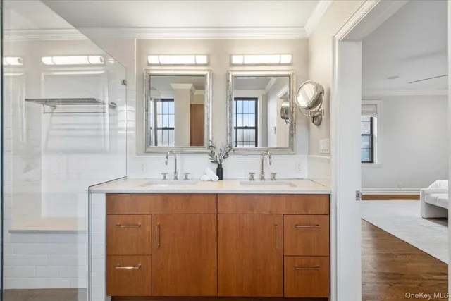 a bathroom with a double vanity sink and mirror