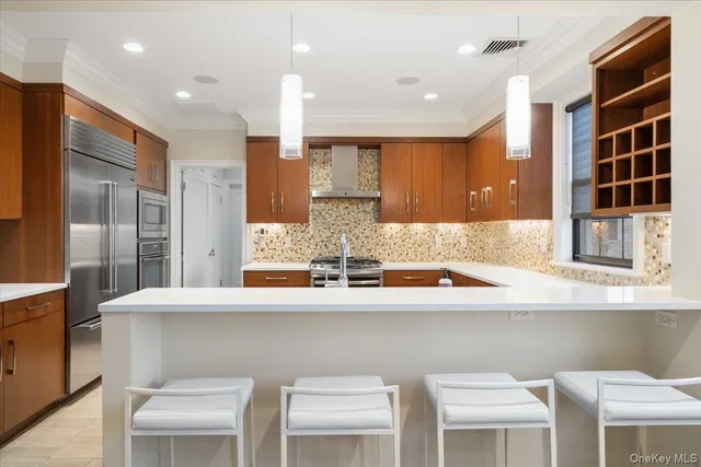 a kitchen with stainless steel appliances granite countertop a sink and a refrigerator