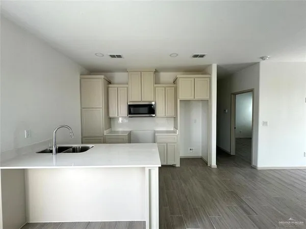 a kitchen with a sink a stove a refrigerator and cabinets