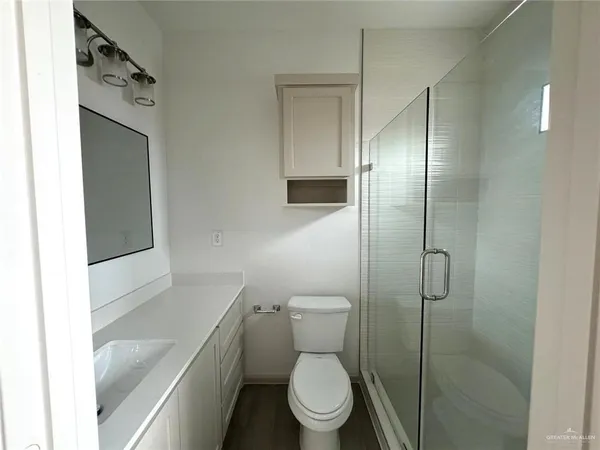 a white toilet sitting next to a bathroom sink