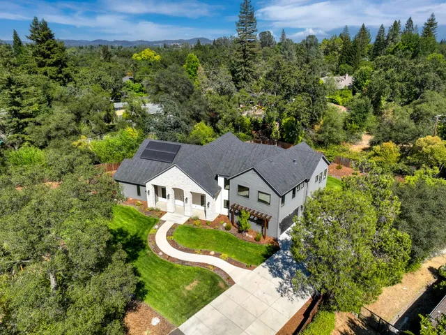a living room with fireplace furniture and a floor to ceiling window