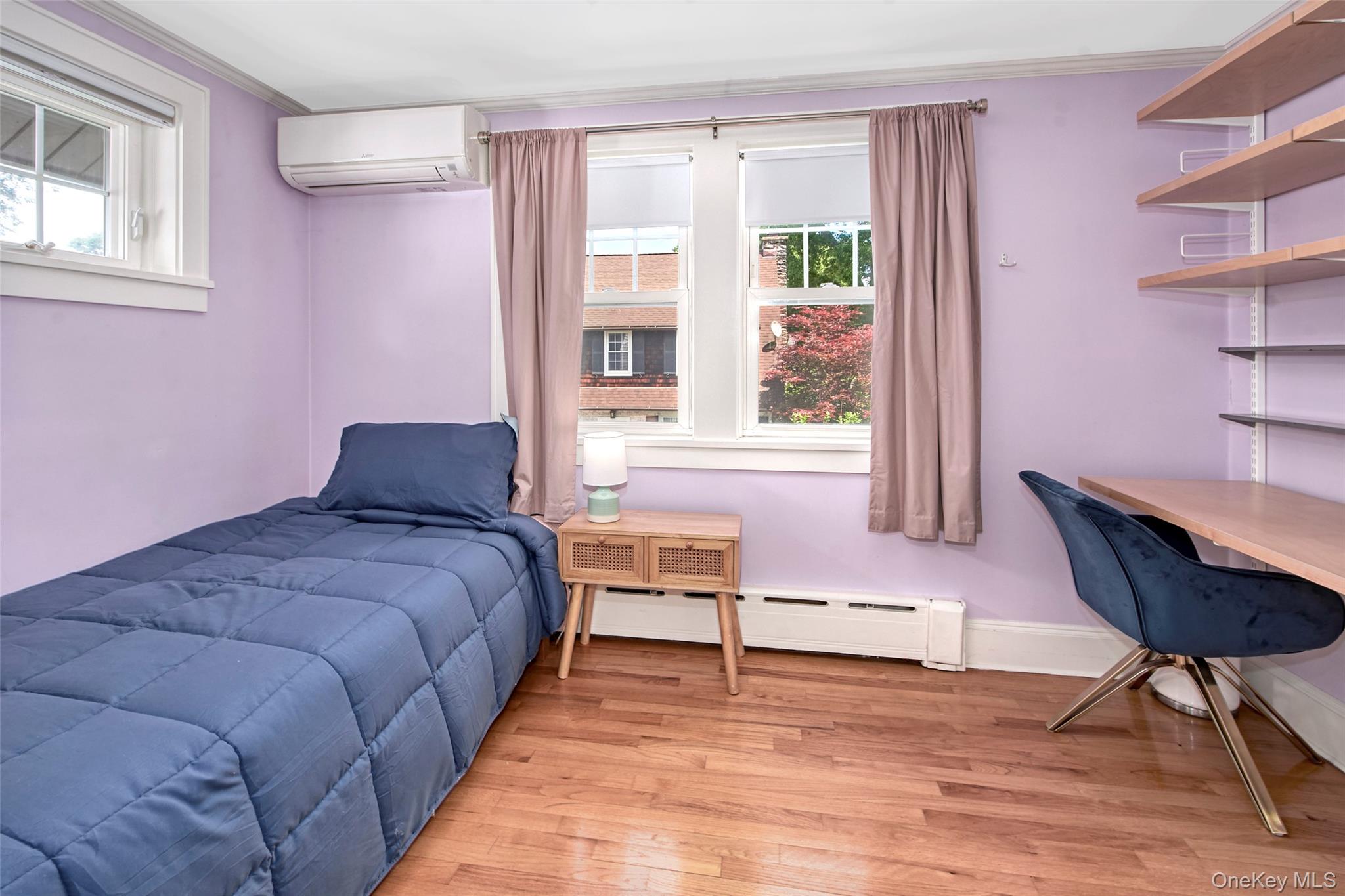 9 Fenton Street Rye, NY 10580 - Photo 15 of 22 Bright and versatile bedroom featuring a comfortable bed, dedicated workspace, hardwood floors, and abundant natural light. Ideal as a guest bedroom, home office, study space, or flexible room to suit a variety of living needs.