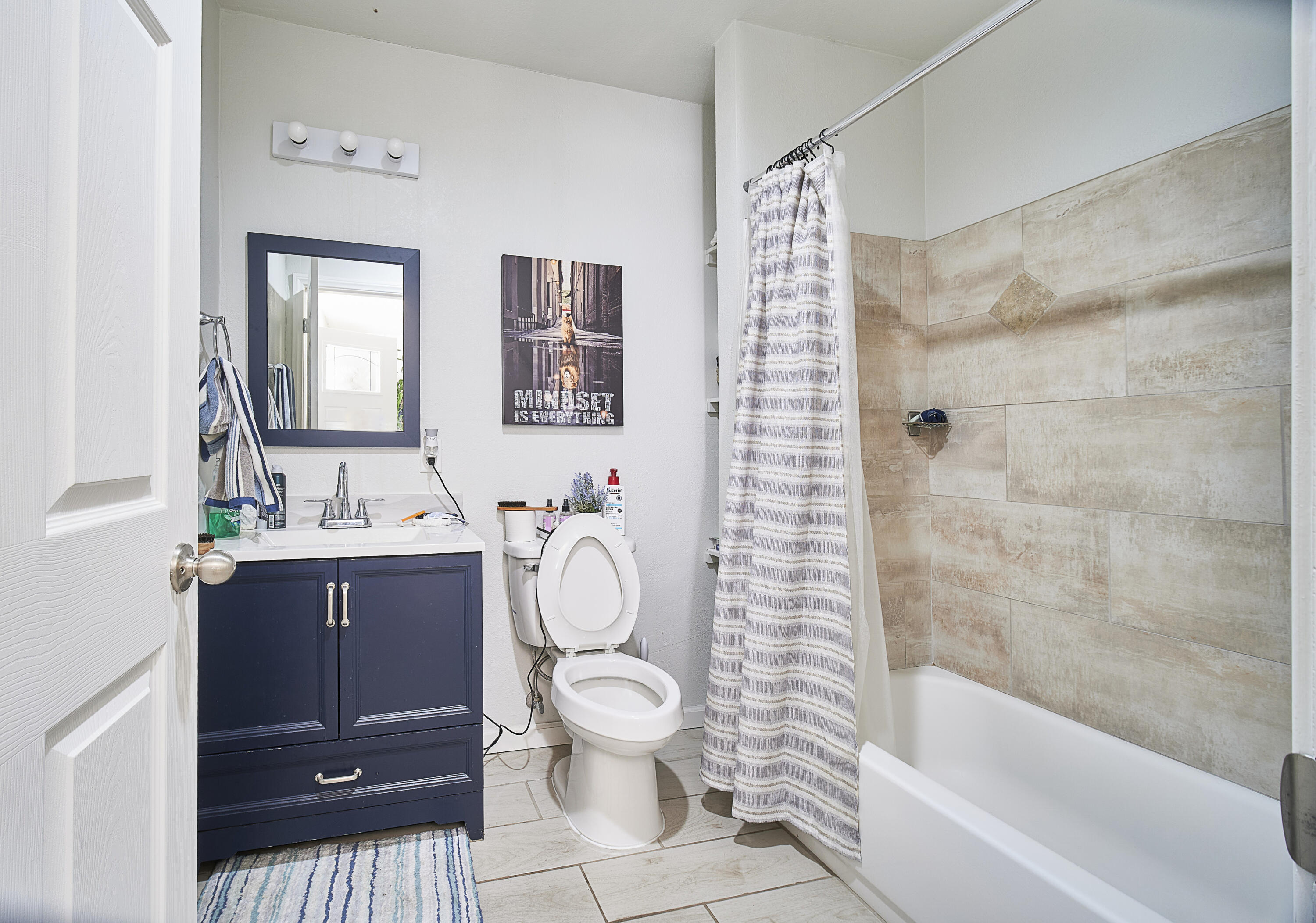 44655 Fig Avenue Lancaster, CA 93534 - Photo 11 of 16 a bathroom with a sink a toilet and shower