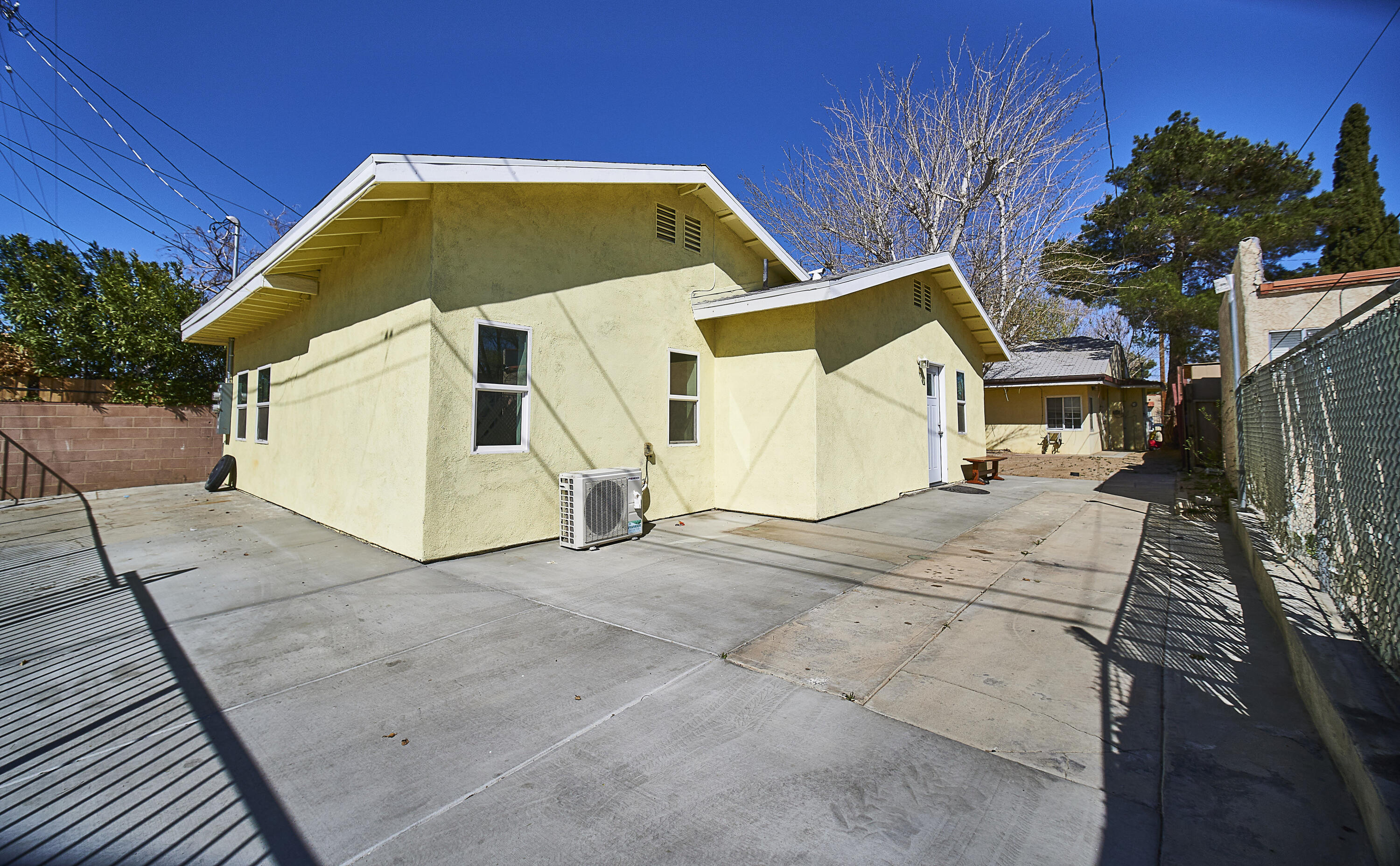 44655 Fig Avenue Lancaster, CA 93534 - Photo 13 of 16 a view of a white house with a yard