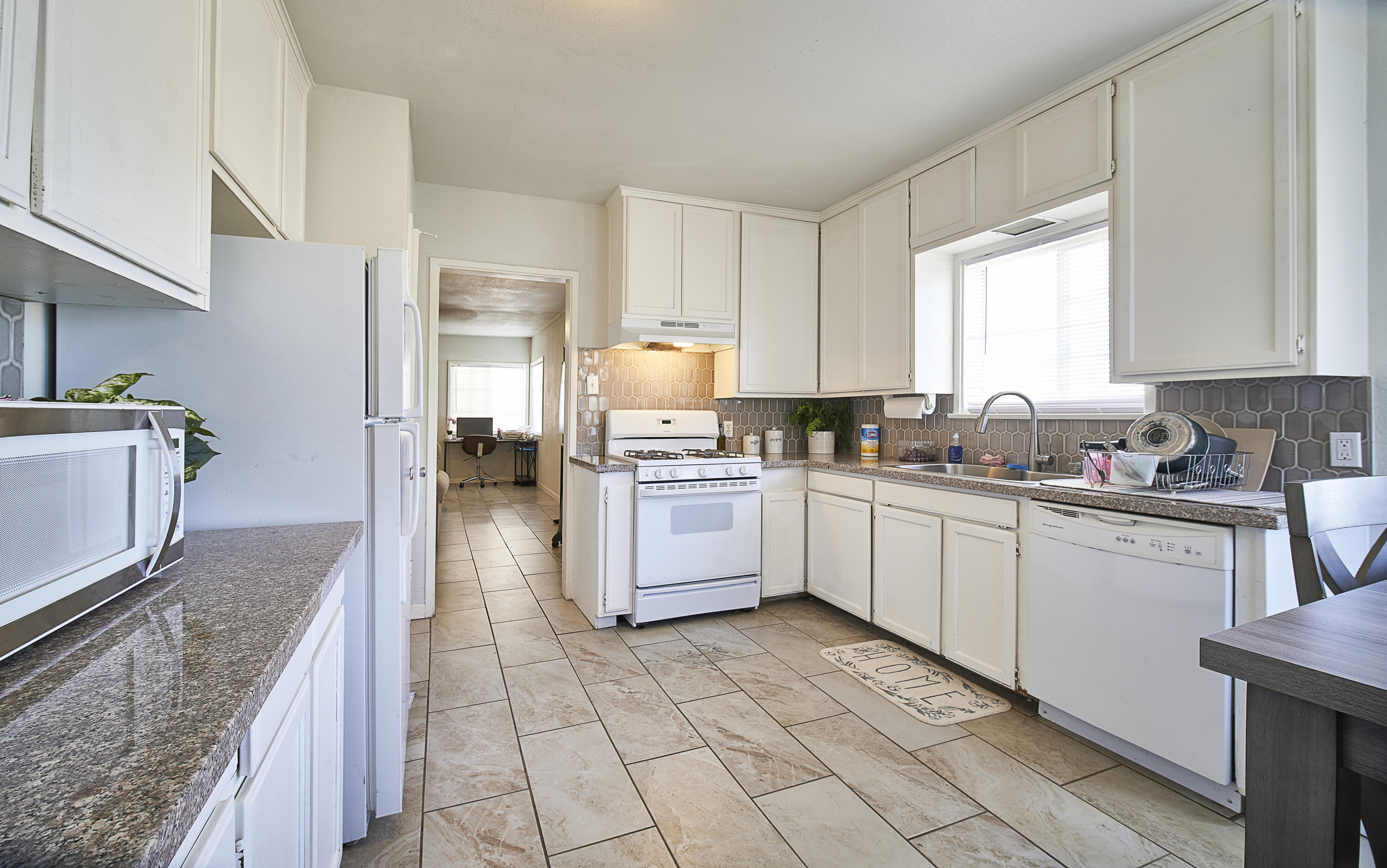44655 Fig Avenue Lancaster, CA 93534 - Photo 4 of 16 a kitchen with stainless steel appliances granite countertop a stove a sink and a microwave