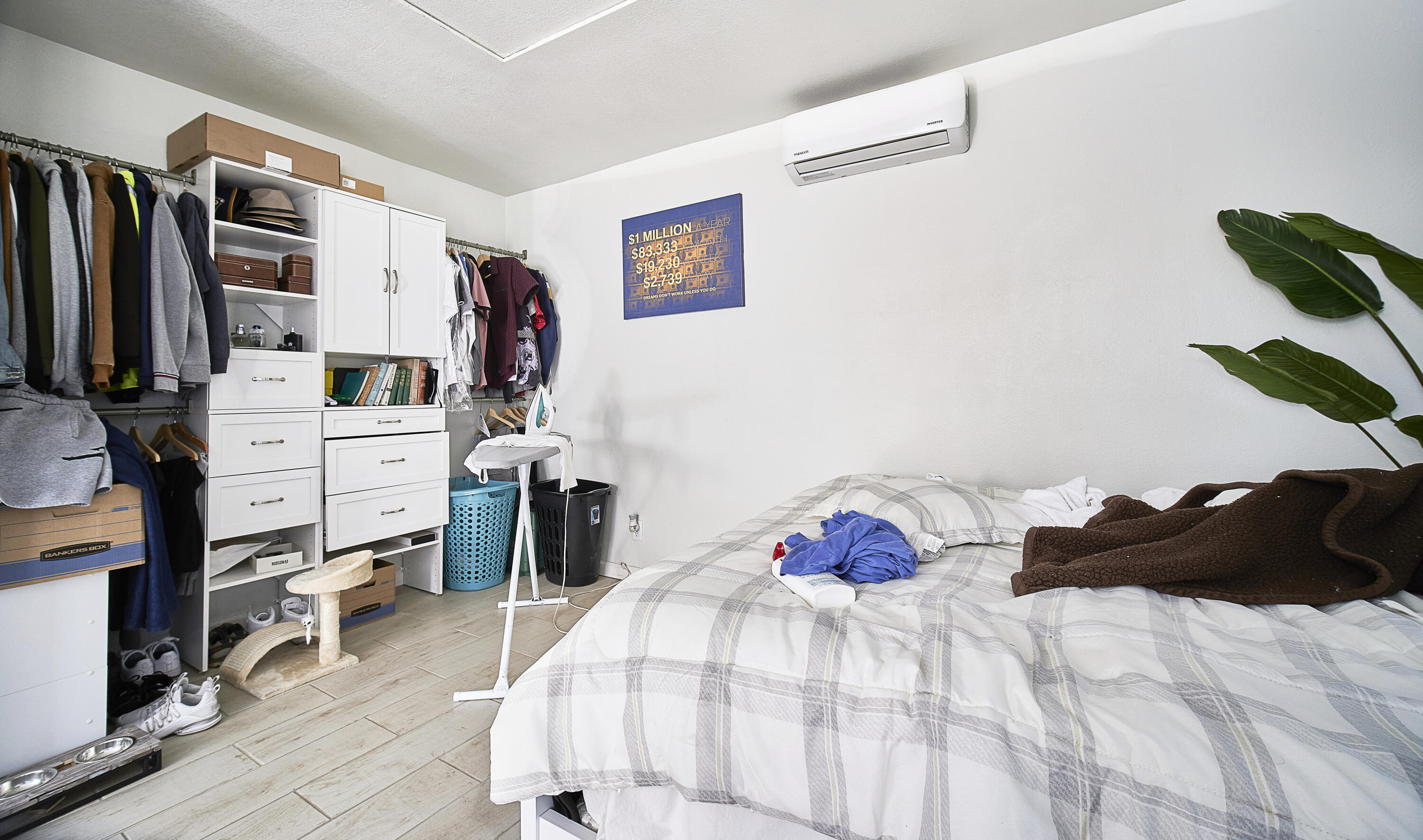 44655 Fig Avenue Lancaster, CA 93534 - Photo 10 of 16 a bedroom with a bed and a walk in closet