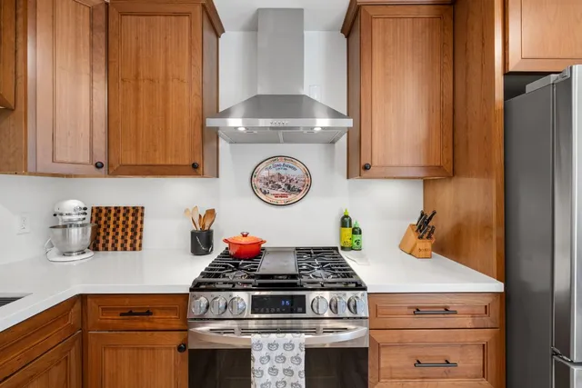 a stove top oven sitting inside of a kitchen