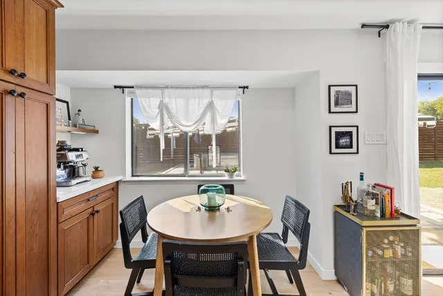 a view of a dining room with furniture and window