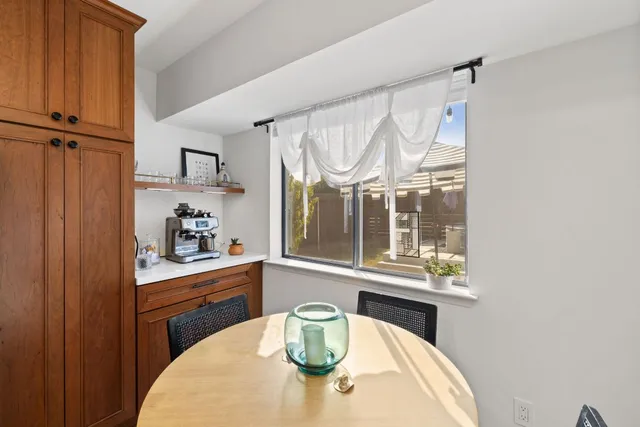 a kitchen with a table and a potted plant