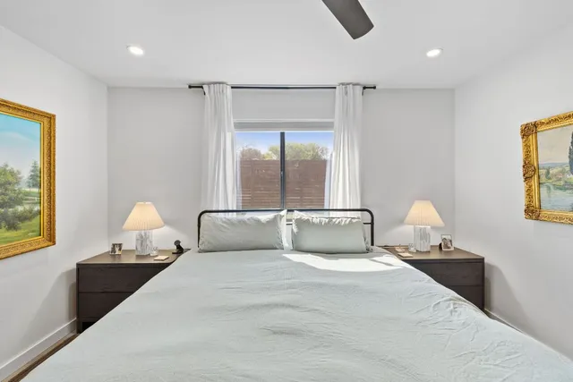 a bedroom with a large bed and a window