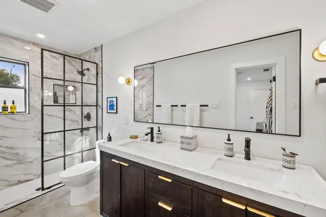 a bathroom with a double vanity sink mirror and double