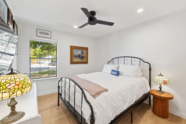 a bedroom with a bed and a chandelier