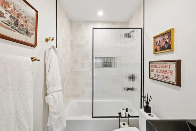 a bathroom with a bathtub and a shower