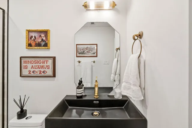 a view of a bathroom with sink and a mirror