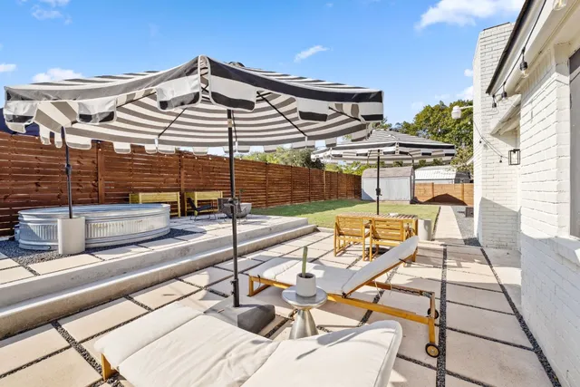 a view of a patio with a table and chairs