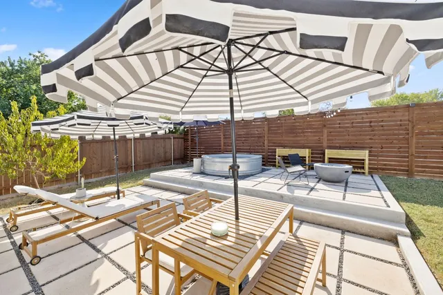 a view of a patio with a table and chairs