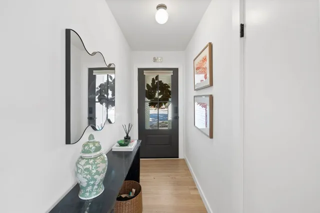 a view of an entryway with wooden floor