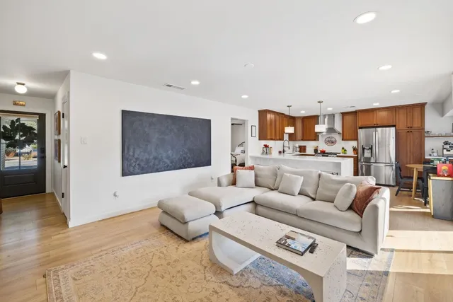 a living room with furniture and kitchen view