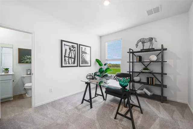 a view of a workspace room with wooden floor and furniture