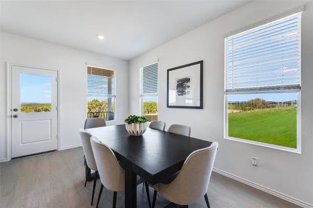 a view of a dining room with a table and chairs