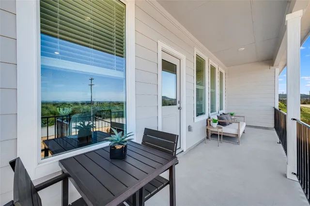 a view of a patio with a dining table and chairs