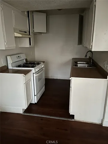 a kitchen with a sink and a stove