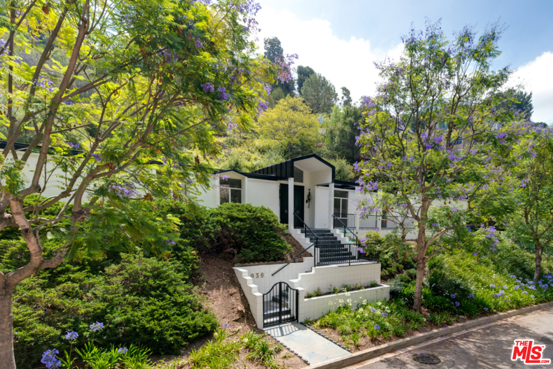 936 Chantilly Road Los Angeles, CA 90077 - Photo 1 of 1 a front view of a house with garden