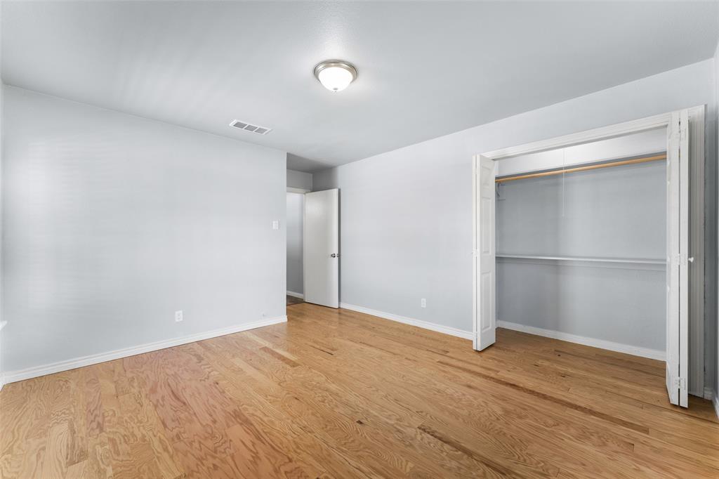 612 East 8th Street Kemp, TX 75143 - Photo 21 of 25 Room featuring wood-finish flooring, light grey walls, and white baseboards