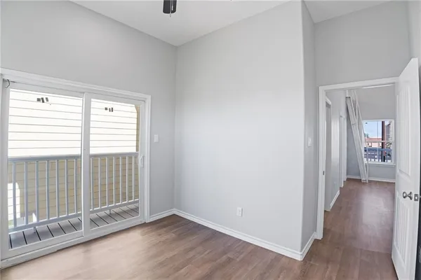 a view of a room with wooden floor