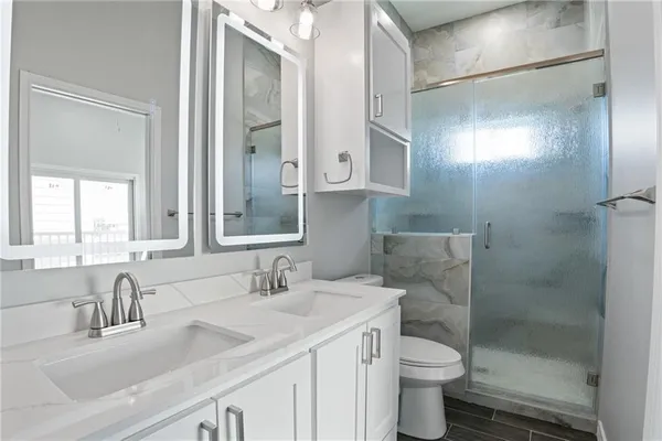 a bathroom with a sink toilet and shower
