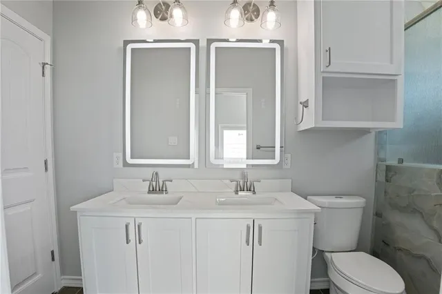 a bathroom with a toilet sink and mirror