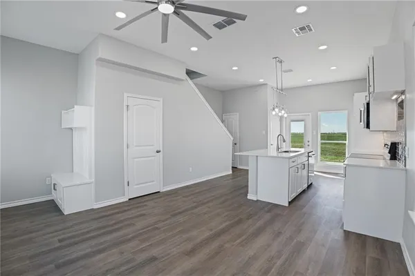 a view of a kitchen with furniture and wooden floor