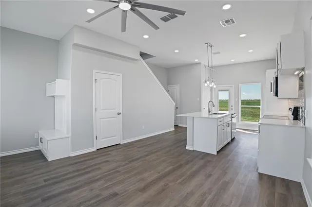a view of a kitchen with furniture and wooden floor