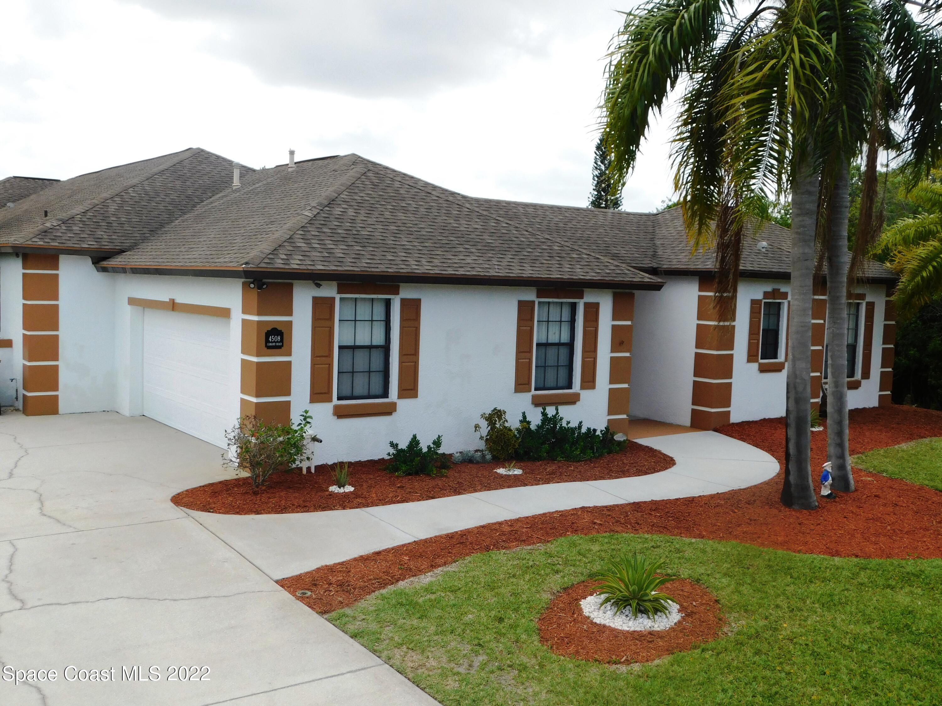4508 Canard Road Melbourne, FL 32934 - Photo 1 of 34 a front view of a house with garden