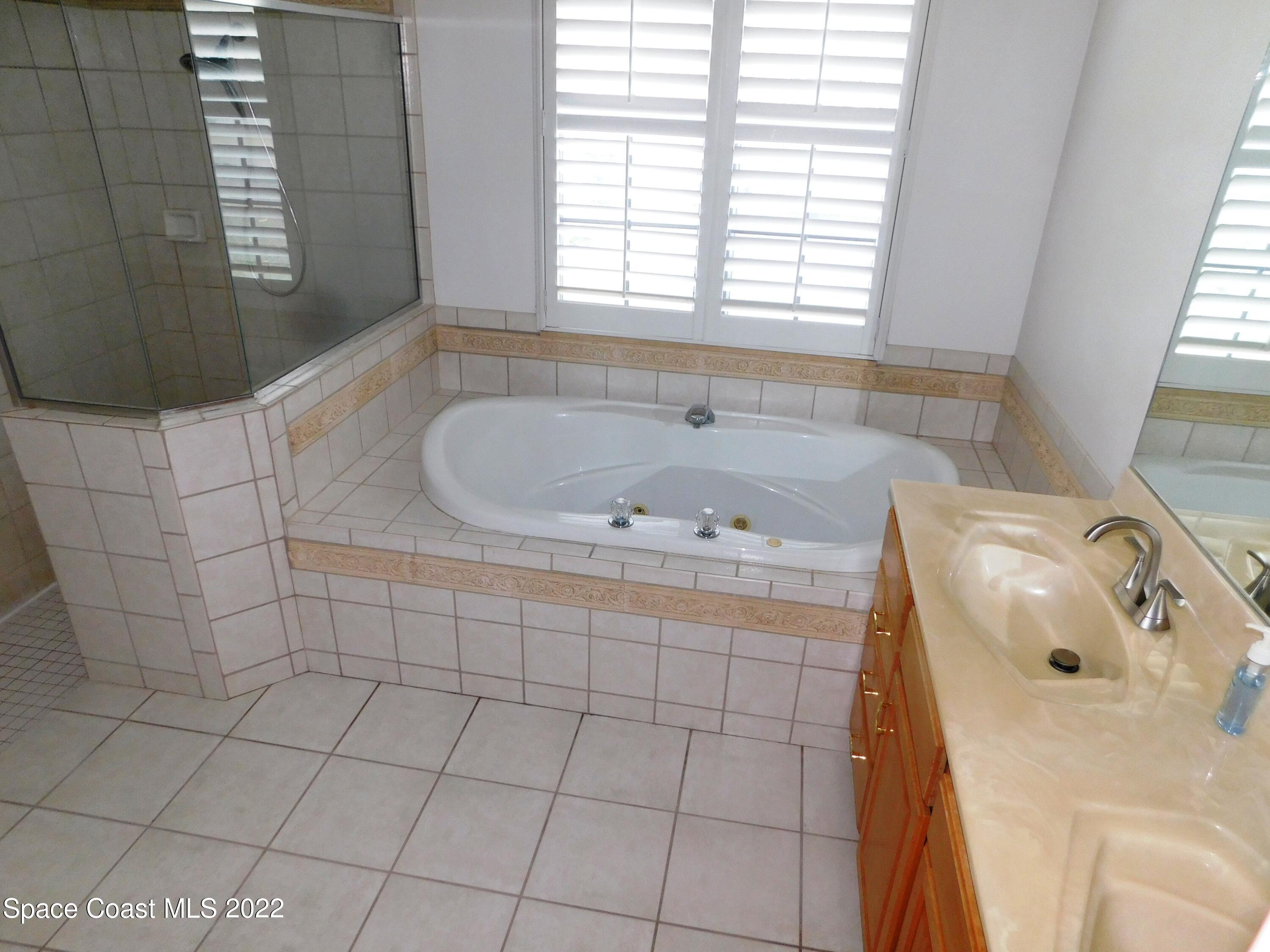4508 Canard Road Melbourne, FL 32934 - Photo 16 of 34 a bathroom with a sink and a bathtub