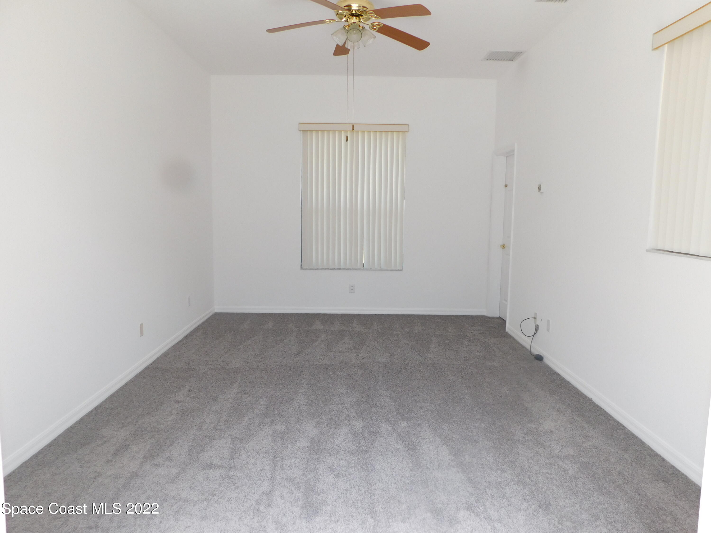 4508 Canard Road Melbourne, FL 32934 - Photo 17 of 34 an empty room with a window and a ceiling fan