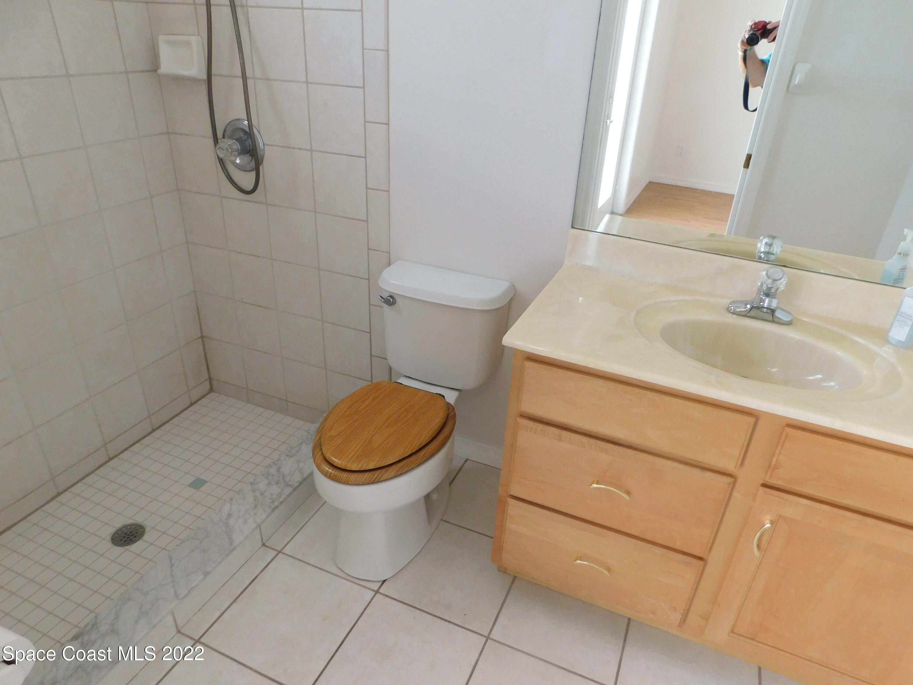 4508 Canard Road Melbourne, FL 32934 - Photo 23 of 34 a bathroom with a sink a toilet and shower