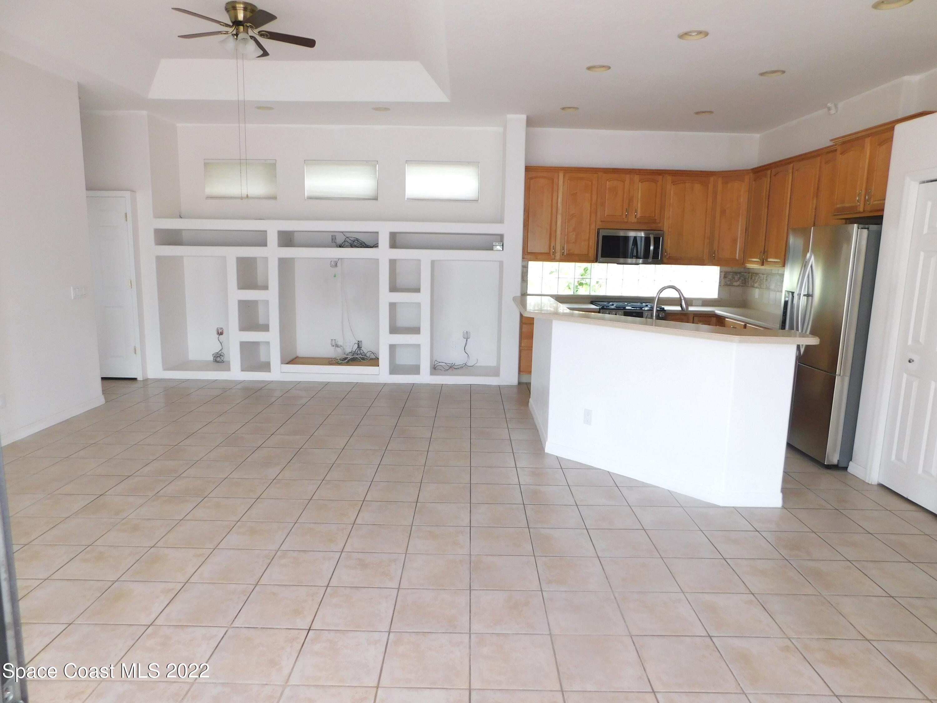 4508 Canard Road Melbourne, FL 32934 - Photo 8 of 34 a kitchen with stainless steel appliances a refrigerator and microwave