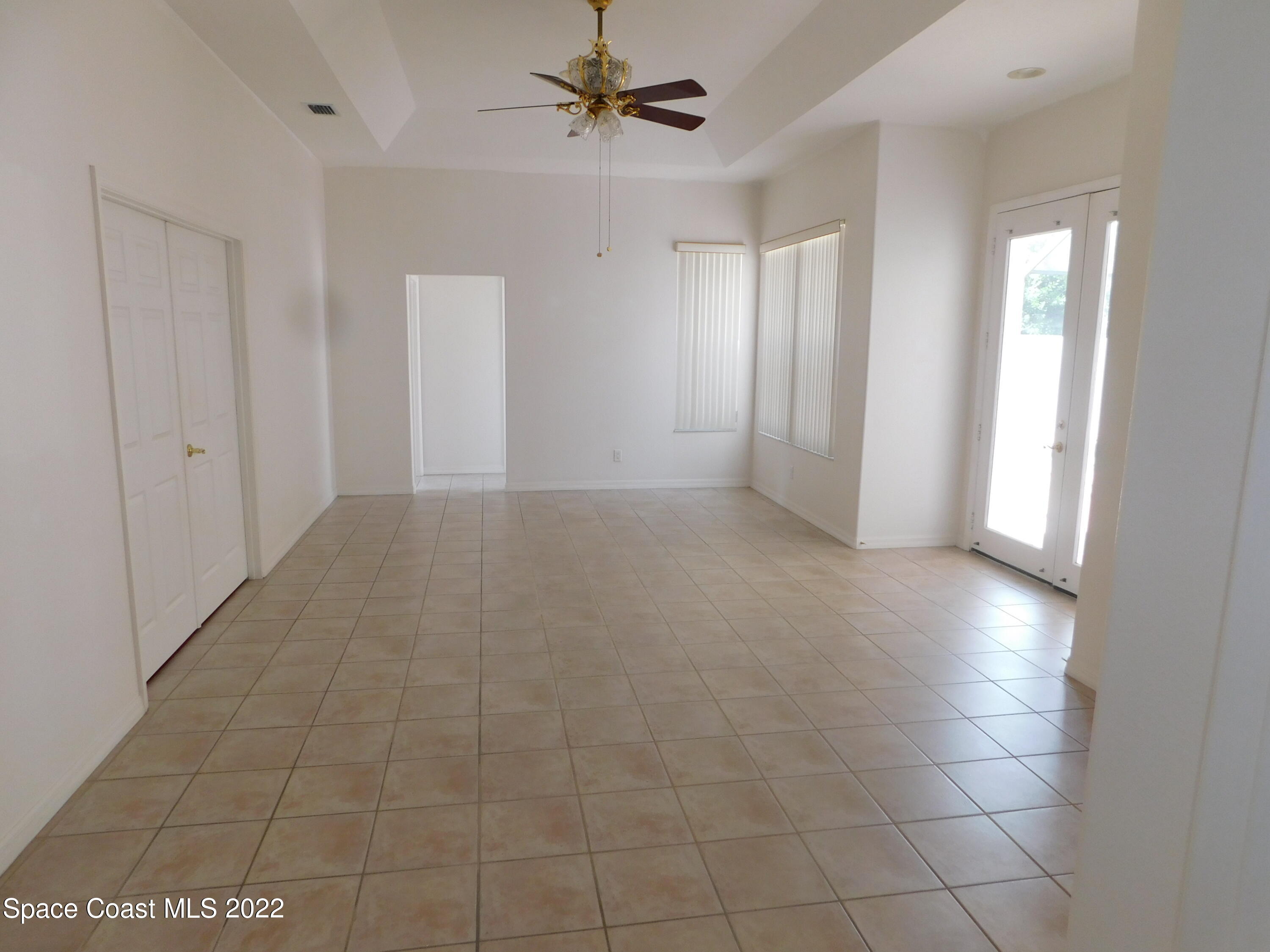 4508 Canard Road Melbourne, FL 32934 - Photo 10 of 34 a view of a livingroom with a chandelier fan and windows