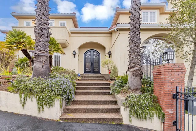 a living room with furniture fireplace and a large window