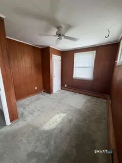 an empty room with windows and closet