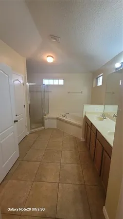 a bathroom with a sink a toilet a mirror and shower