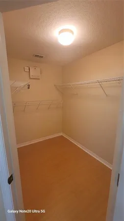 an empty room with a ceiling fan and window