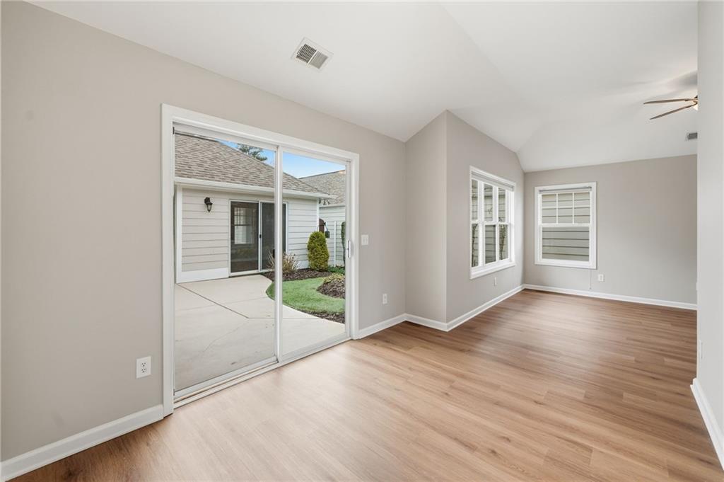 309 Jessica Way Canton, GA 30114 - Photo 11 of 27 an empty room with wooden floor and windows