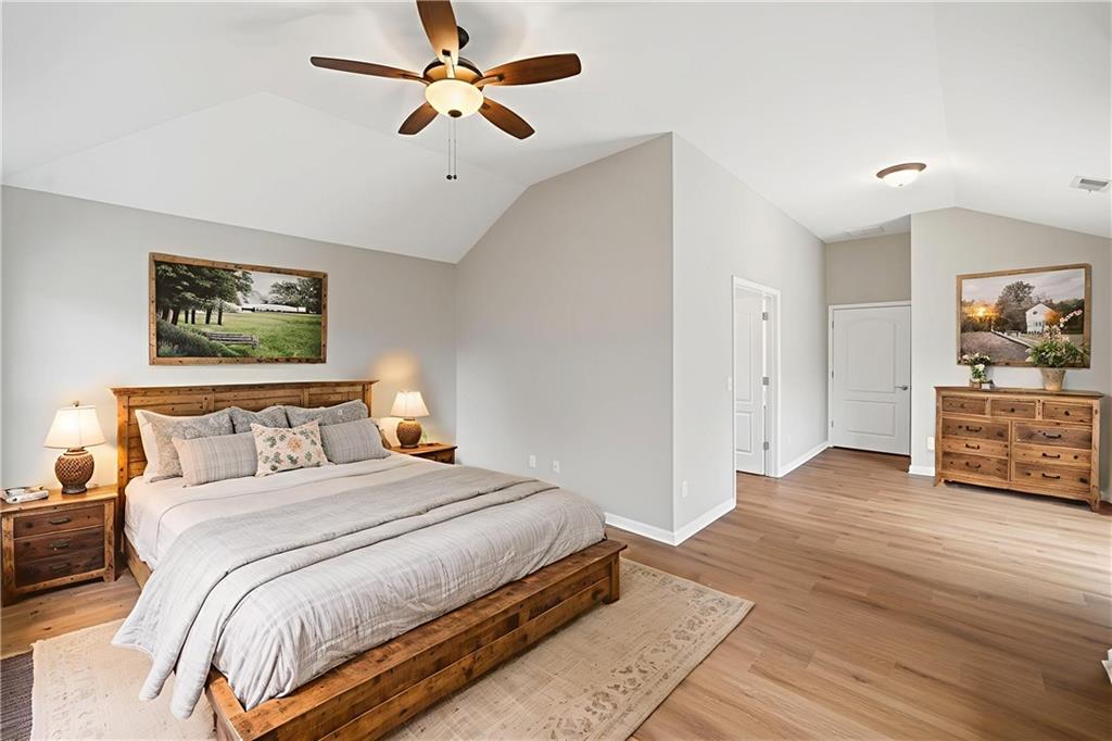 309 Jessica Way Canton, GA 30114 - Photo 13 of 27 a bedroom with a bed and a chandelier