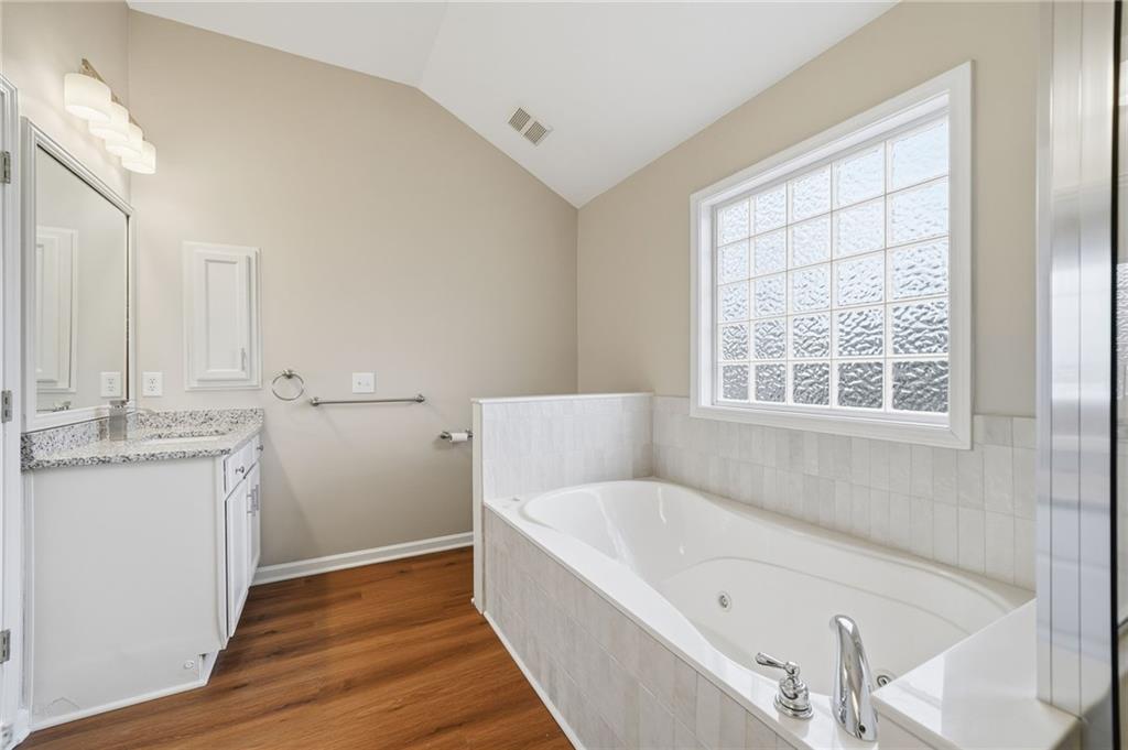 309 Jessica Way Canton, GA 30114 - Photo 16 of 27 a bathroom with a bathtub and a sink